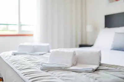 two white towels sitting on top of a bed at Ivory Breeze by Elysian in Funchal