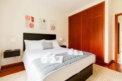 a bedroom with a large bed with towels on it at Ivory Breeze by Elysian in Funchal