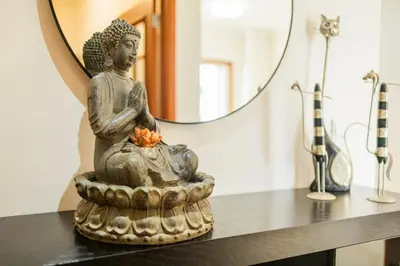 a statue sitting on a table in front of a mirror at Ivory Breeze by Elysian in Funchal