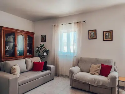 a living room with a couch and a chair at Villa Victoria, Tonel, Sagres in Sagres