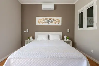 a bedroom with a large bed with white sheets at Madeira Loft by Mathias in Funchal