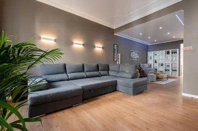 a living room with a gray couch in a room at Madeira Loft by Mathias in Funchal