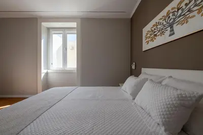 a bedroom with a white bed and a window at Madeira Loft by Mathias in Funchal