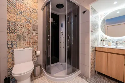 a bathroom with a shower and a toilet and a sink at Madeira Loft by Mathias in Funchal