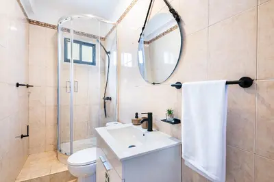 a bathroom with a toilet sink and a mirror at Crab House 01 by GALMI in Machico
