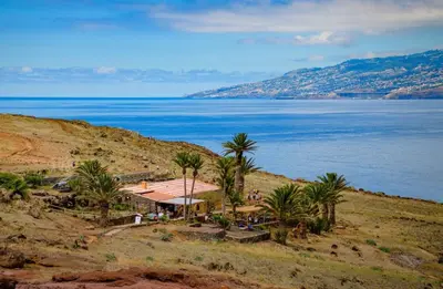 a house on a hill next to the water at Crab House 01 by GALMI in Machico
