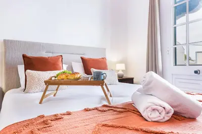a bed with a tray of fruit on it at Crab House 02 by GALMI in Machico