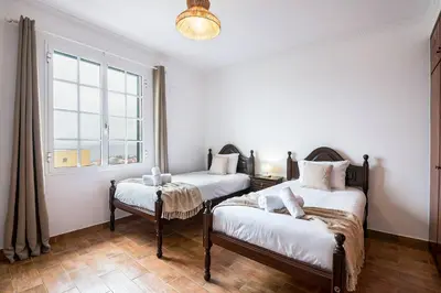a room with two beds and a window at Crab House 02 by GALMI in Machico