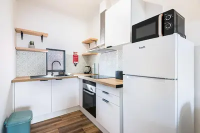 a white kitchen with a refrigerator and a sink at Crab House 02 by GALMI in Machico