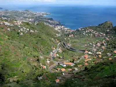 an aerial view of a village on a hill next to the ocean at Villa Getaway in Santo António da Serra in Santo da Serra
