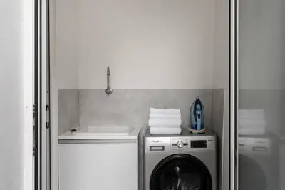 a laundry room with a washing machine and a sink at Casa Branca 36 by An Island Apart in Funchal