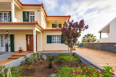 a bed with a nightstand with a lamp on it at Ocean Side Vista by YOUR KEY in Funchal