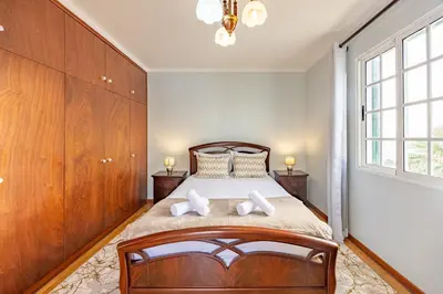 a living room with a white couch and a tv at Ocean Side Vista by YOUR KEY in Funchal