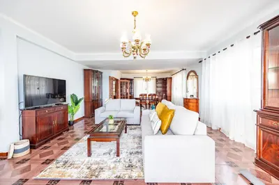 a bed with green and white pillows on it at Ocean Side Vista by YOUR KEY in Funchal