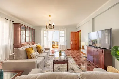 a living room with a couch and a tv at Ocean Side Vista by YOUR KEY in Funchal