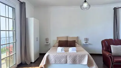 a bedroom with a bed with two towels on it at Golden Horizon House By Sam Houses in Ponta do Sol
