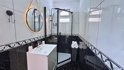 a bathroom with a sink and a mirror at Golden Horizon House By Sam Houses in Ponta do Sol