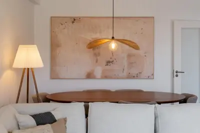 a living room with a table and a painting at Apartamento Ajuda-Madeira by An Island Apart in Funchal