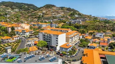 an aerial view of a city with a mountain at Amethyst Scape Caniço Madeira by GRM in Caniço