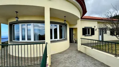 a house with a balcony with a view of the ocean at Golden View in Gaula