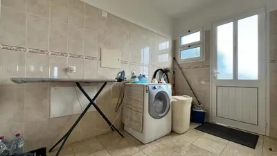 a laundry room with a washing machine and a window at Golden View in Gaula