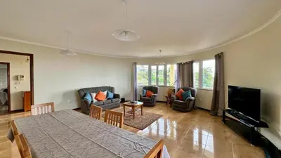 a living room with a bed and a couch and a television at Golden View in Gaula