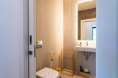 a bathroom with a toilet and a sink and a mirror at GuestReady - Acqua residences in Funchal
