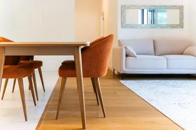 a dining room table with chairs and a couch at GuestReady - Acqua residences in Funchal