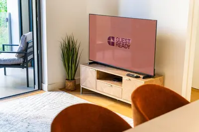 a flat screen tv sitting on a stand in a living room at GuestReady - Acqua residences in Funchal