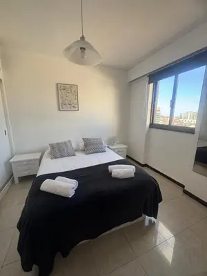 a bedroom with a large bed with two towels on it at My Sun Holidays in Funchal