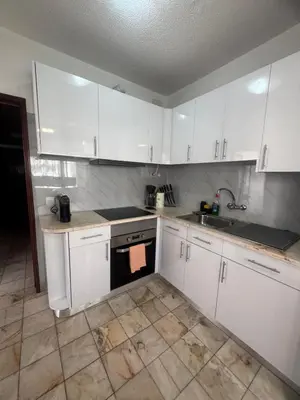 a kitchen with white cabinets and a sink at My Sun Holidays in Funchal