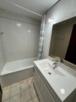 a bathroom with a sink and a tub and a mirror at My Sun Holidays in Funchal