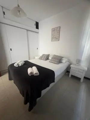 a bedroom with a bed with two slippers on it at My Sun Holidays in Funchal