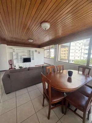 a dining room with a table and a couch at My Sun Holidays in Funchal