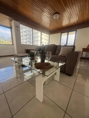 a living room with a glass table and a couch at My Sun Holidays in Funchal