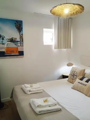 a bedroom with a bed with two pillows on it at Villa Baía in Funchal