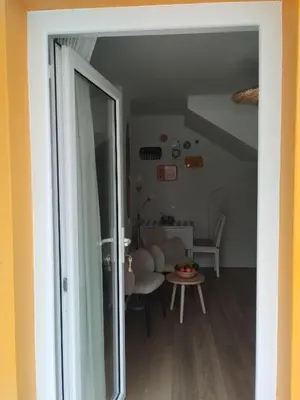a kitchen with white cabinets and a large window at Villa Baía in Funchal