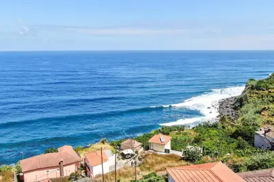 an aerial view of the ocean with houses at Casinha do Mar by GALMI in São Vicente