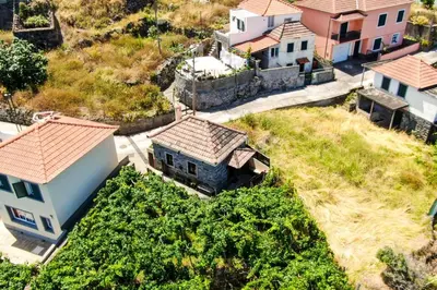 an aerial view of a village with houses and crops at Casinha do Mar by GALMI in São Vicente