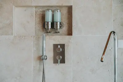 a shower in a bathroom with a shower head at Port and Stone Villa in Funchal