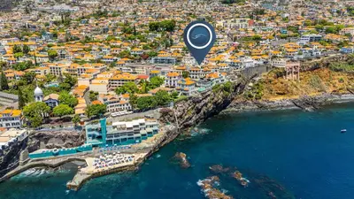 an aerial view of a city with a beach and the ocean at Port and Stone Villa in Funchal