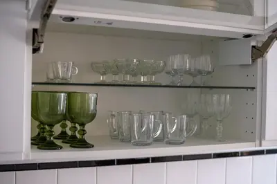 a bunch of glasses on a shelf in a kitchen at Casa Branca do Monte in Funchal
