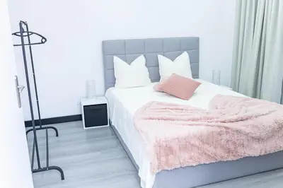 a bedroom with a bed with a pink blanket on it at MCM Matur Flats 2, 11 Duplex in Santa Cruz