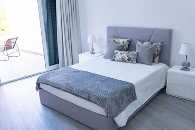 a bedroom with a king sized bed and a balcony at MCM Matur Flats 2, 11 Duplex in Santa Cruz