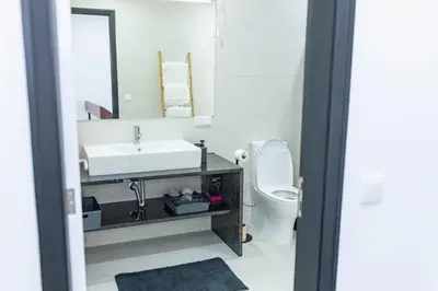 a bathroom with a sink and a toilet and a mirror at MCM Matur Flats 2, 11 Duplex in Santa Cruz