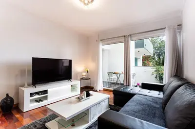 a dining room with a table and black chairs at Casa Nobrega in Caniço