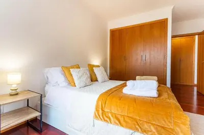 a living room with a couch and a large window at Casa Nobrega in Caniço
