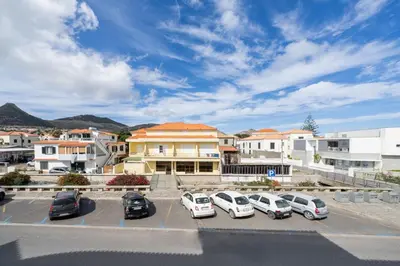 a group of cars parked in a parking lot at Apartamento da Vila by An Island Apart in Porto Santo
