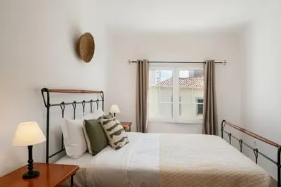 a bedroom with a bed and a window at Apartamento da Vila by An Island Apart in Porto Santo