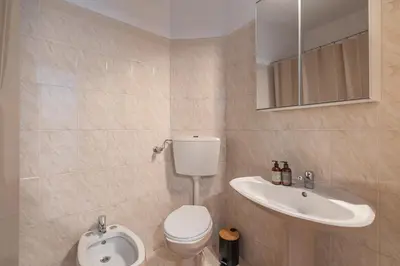 a bathroom with a toilet and a sink at Blue House Burgau in Burgau